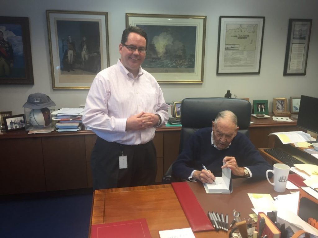Ted G. standing next to Vanguard founder John C. Bogle in office.