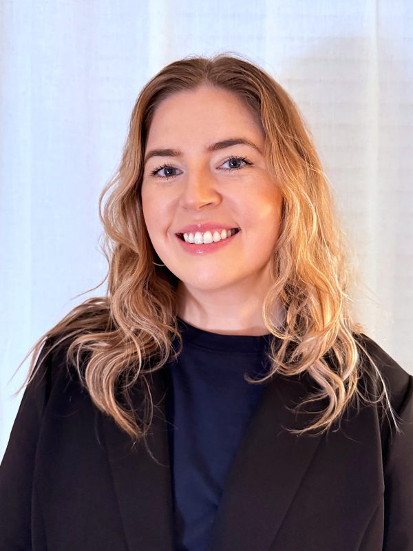 Vanguard_Social_WebContent_Headshots_Vertical_ReannaE_600x800_02_10_2026 Illustration of two people standing under a leafy tree.