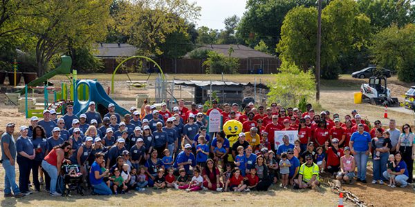 A photo featuring a large group of Vanguard Dallas crew and community members gathered at Cosmos Montessori during the 2025 Global Day of Impact in Dallas, Texas.