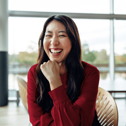 Seated woman laughing.
