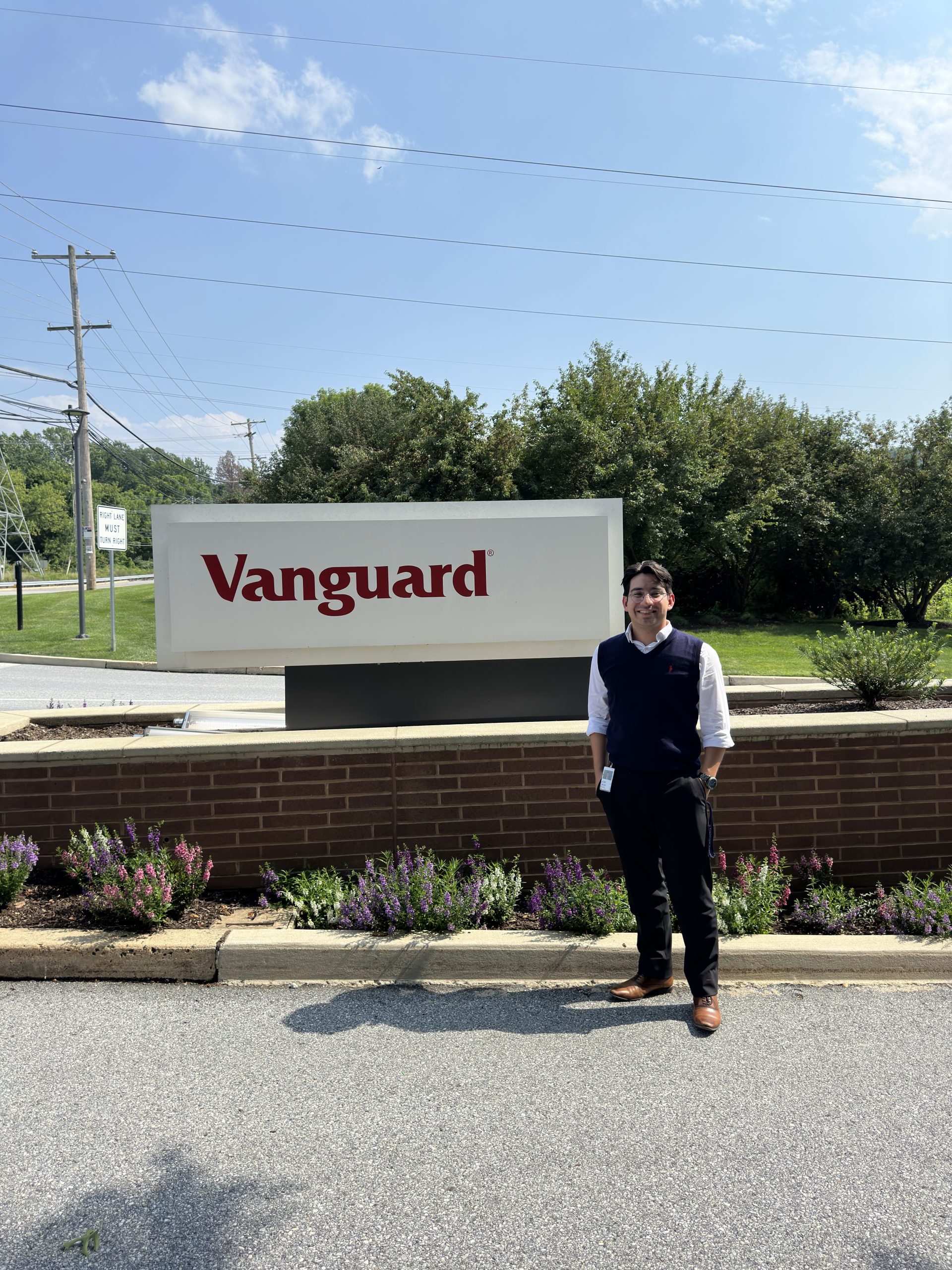Jose standing in front of the Vanguard sign during his internship