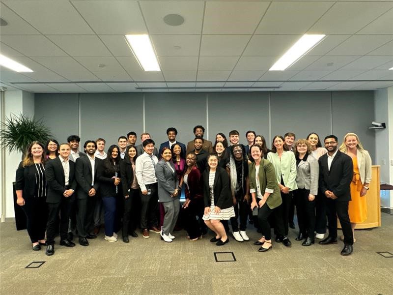Quentine standing in a room with his TLP cohort. 